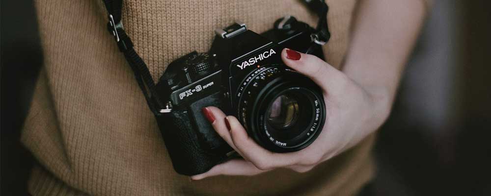 Woman holding a camera.