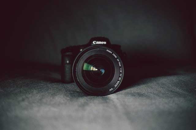 A Canon camera against a grey backdrop