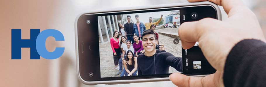 Friends take a group photo on their phone.