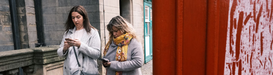 2 women looking at their phones