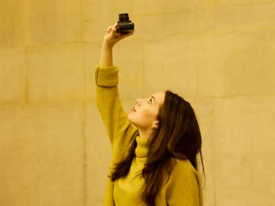 Woman pointing a camera upwards