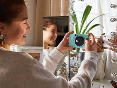 Woman taking a selfie with the Canon Zoemini C