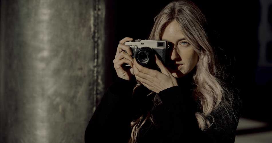 Woman taking a picture with the Fujifilm X-Pro 3 