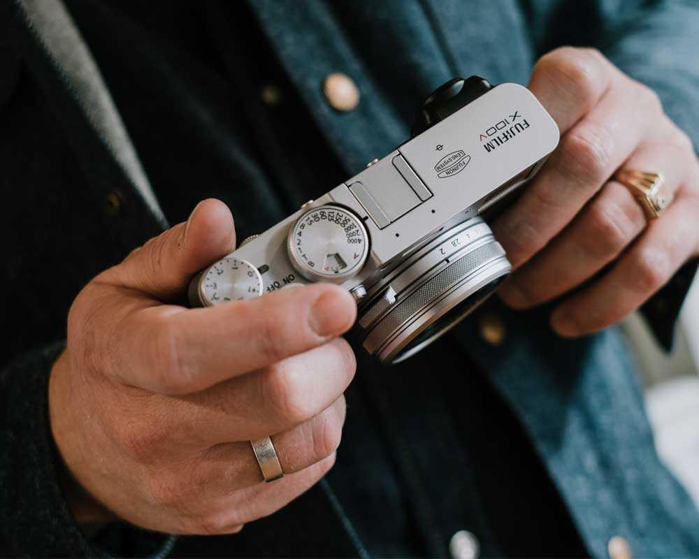 Person holding the Fujifilm X100V.