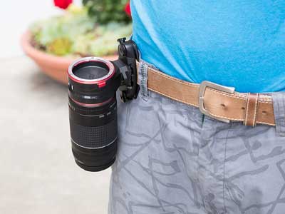 Man using the Peak Design lens kit on his belt strap.