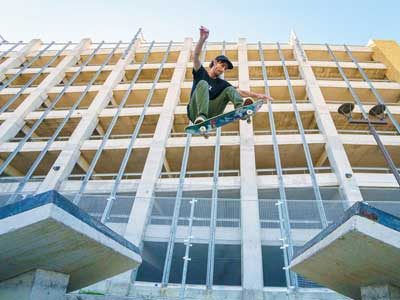 Skater jumping between a gap.